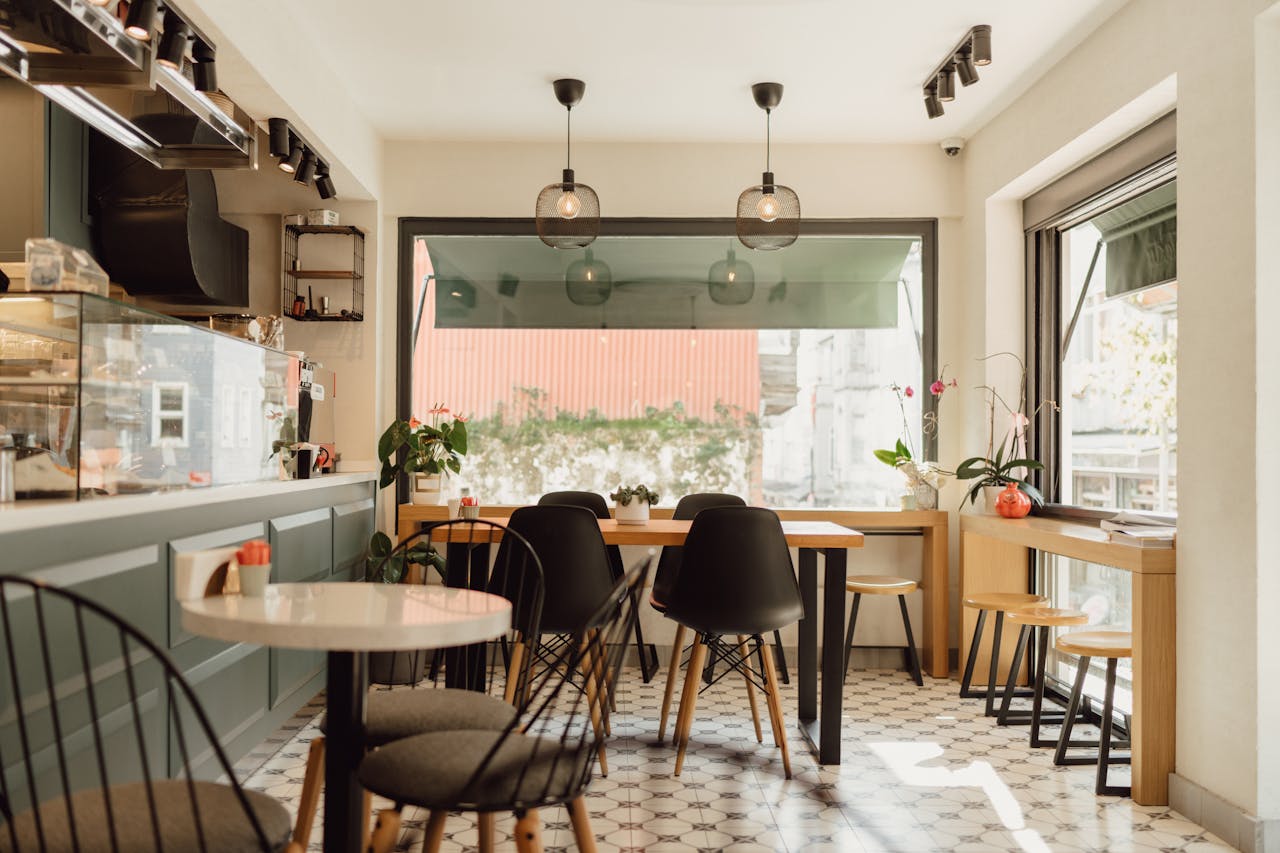A modern, sunlit café in Arnavutköy, Istanbul featuring sleek furniture and minimalist design.